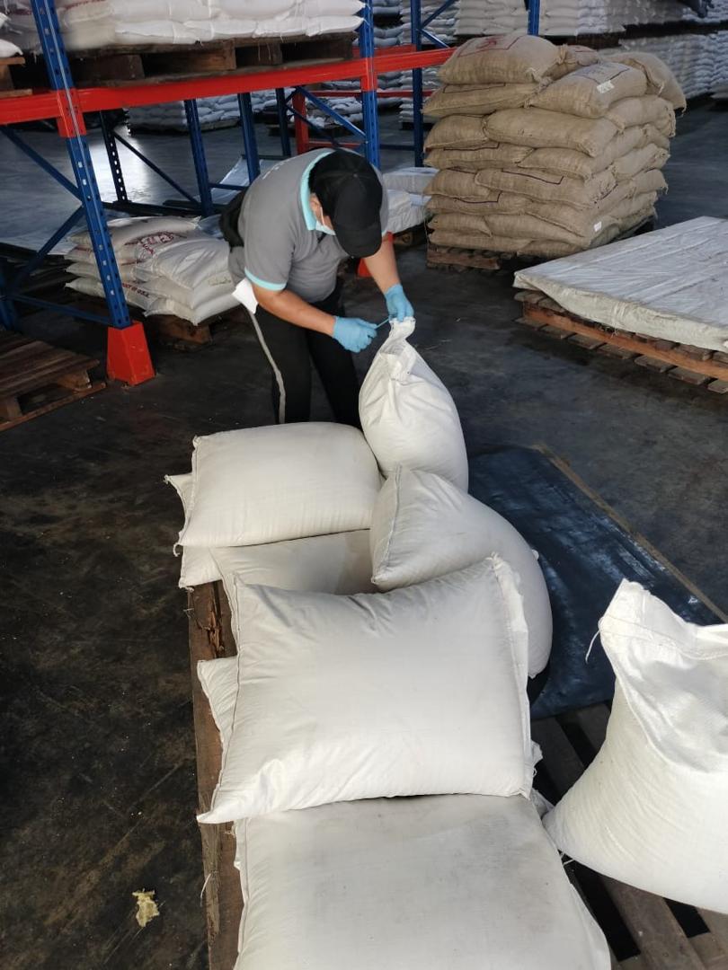 Warehouse Worker Tying Sack 2