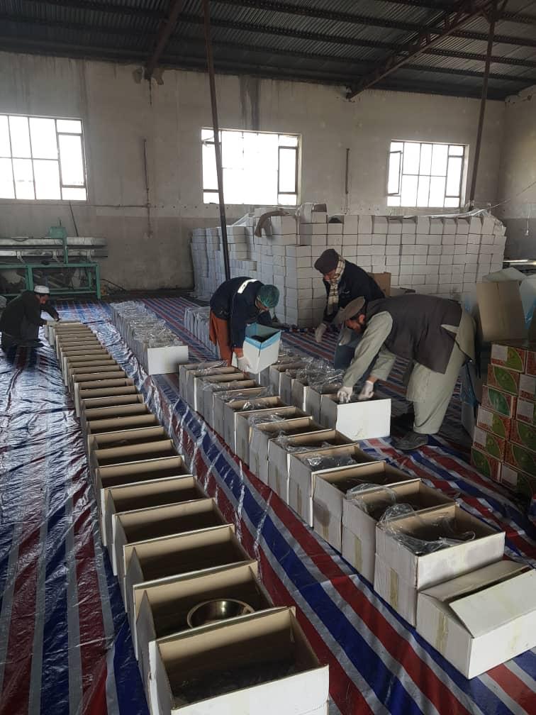 Warehouse Workers Packing Metal Bowls