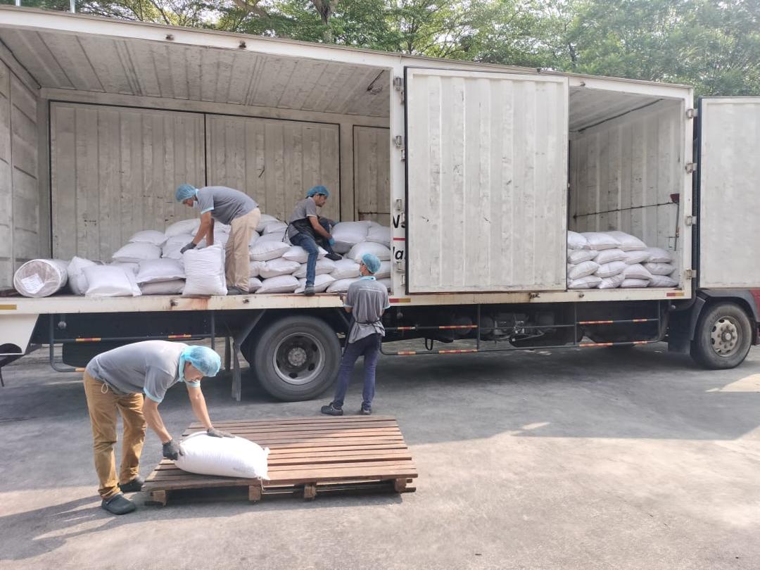 Workers Loading Sacks Into Truck 2